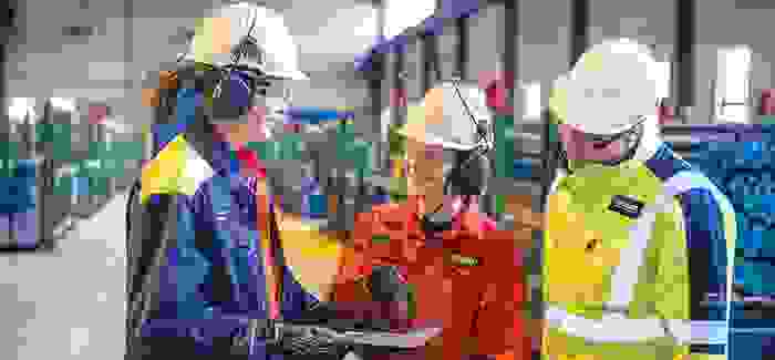 Group of employees in production site