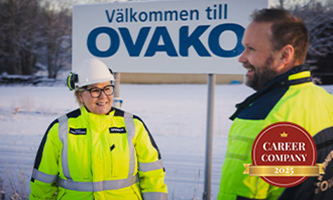 Two ovako workers standing outside in front of an Ovako sign