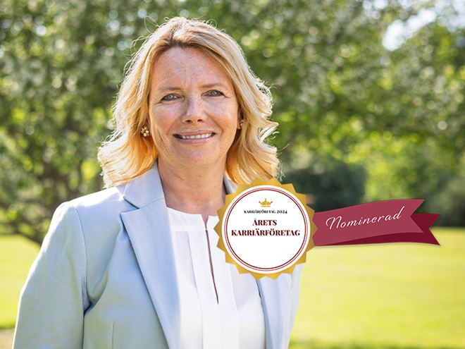 A female HR manager standing in a garden with a logo on it